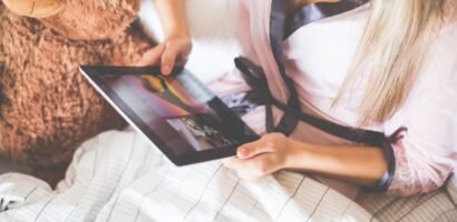 Girl Holding an iPad in Bed